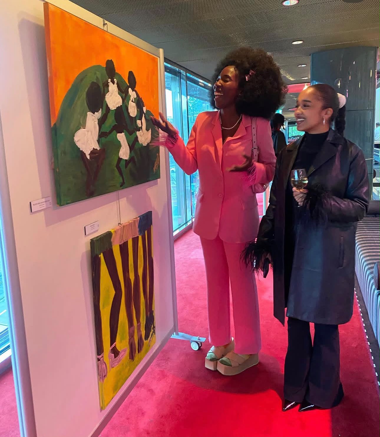 Painting on view with visitors at the exhibition